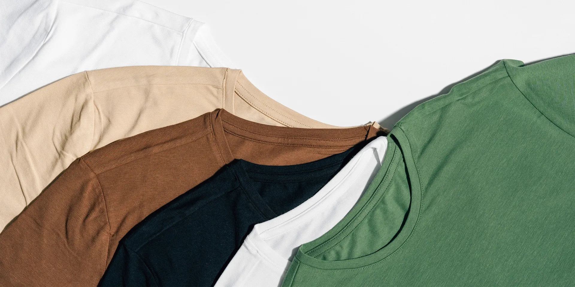 Custom t-shirts flat lay – premium cotton tees personalized by Embedded Designz DFW